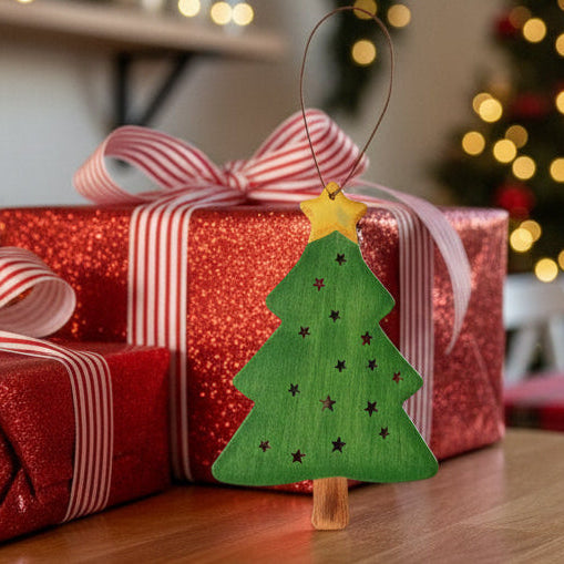 Christmas presents with ribbons on a table in a festive room with a tree in the background