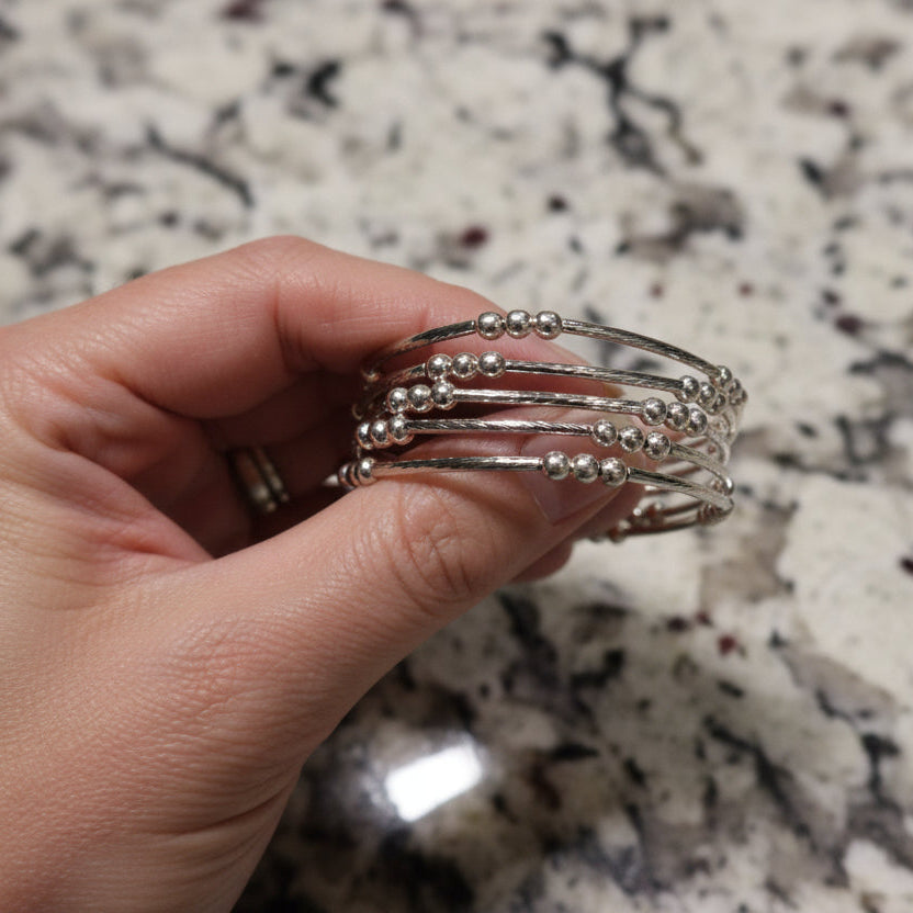 Hand holding a wire bracelet