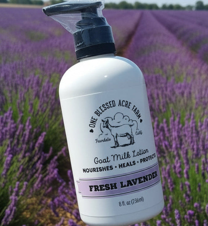 Bottle of goat milk lotion with a pump in front of a lavender field