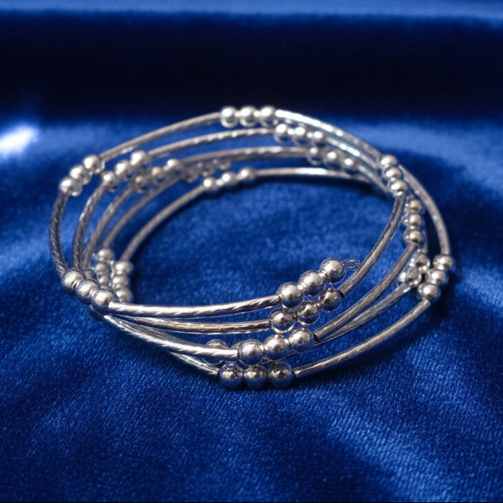 Wire bracelet on blue fabric