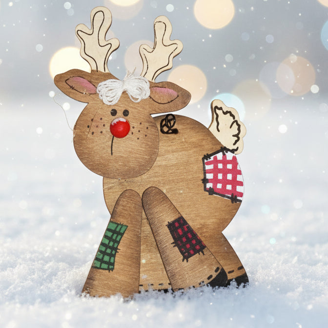 Decorative reindeer figure with a checkered scarf on a snowy background with bokeh lights.