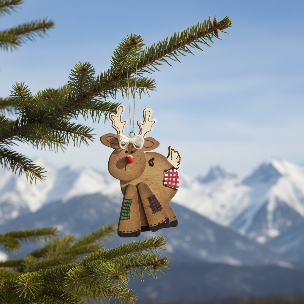 Hand holding a wooden reindeer ornament with a plain background