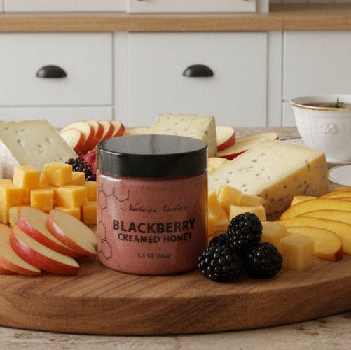 Jar of blackberry honey on a marble surface
