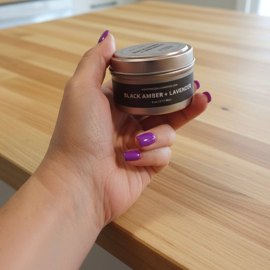 Hand holding a small container of blacksmith lavender on a patterned surface