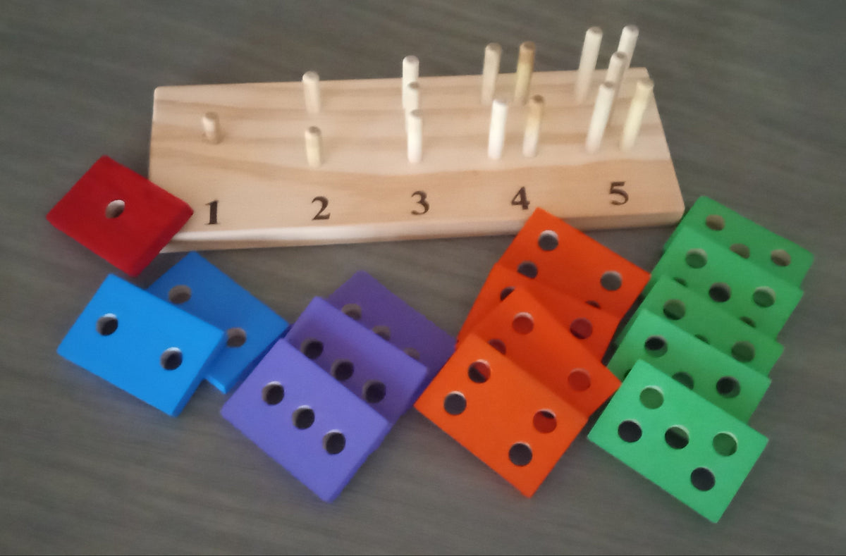 Teach a child to count with  geometric shapes with holes on a wooden pegboard 